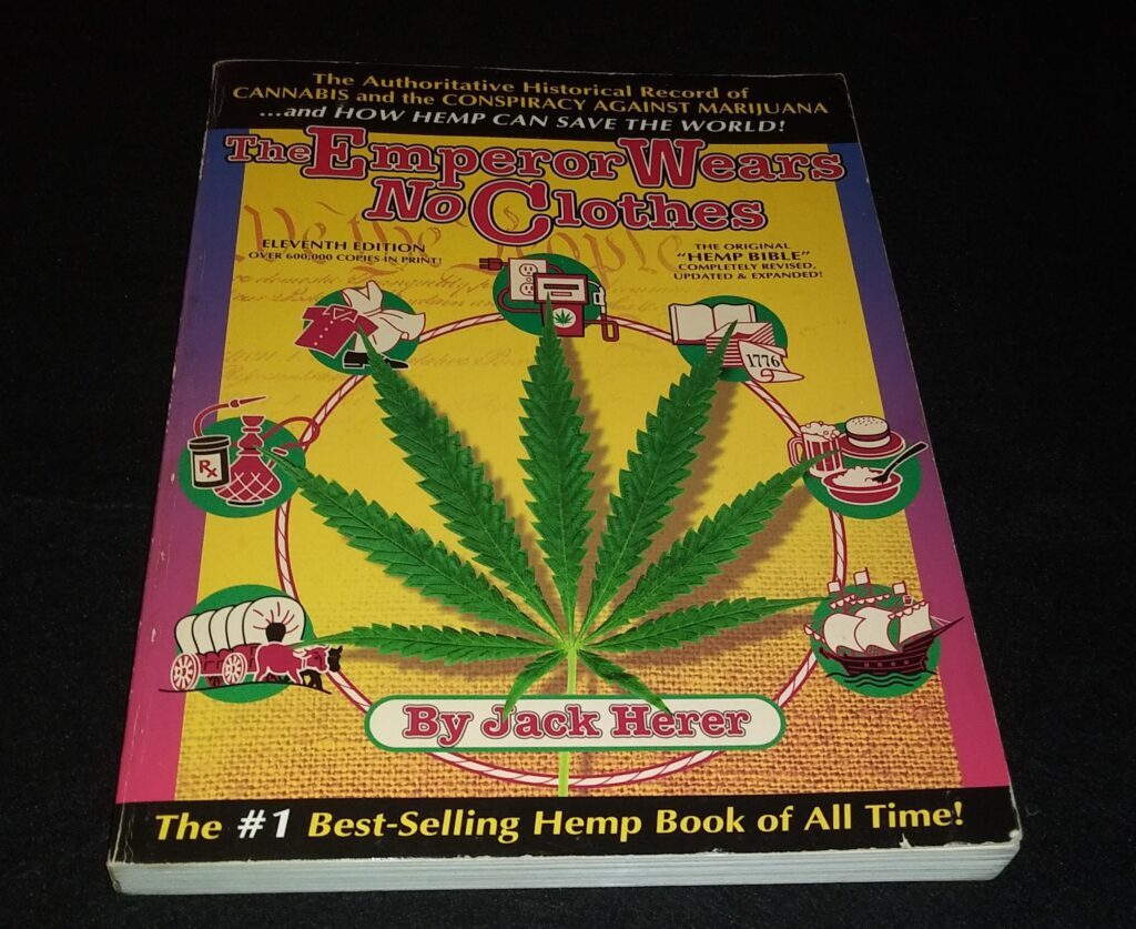 The cover of the book "The Emperor Wears No Clothes" by Jack Herer shows a bright cannabis leaf. It is surrounded by pictures that show how hemp can be used in different industries.