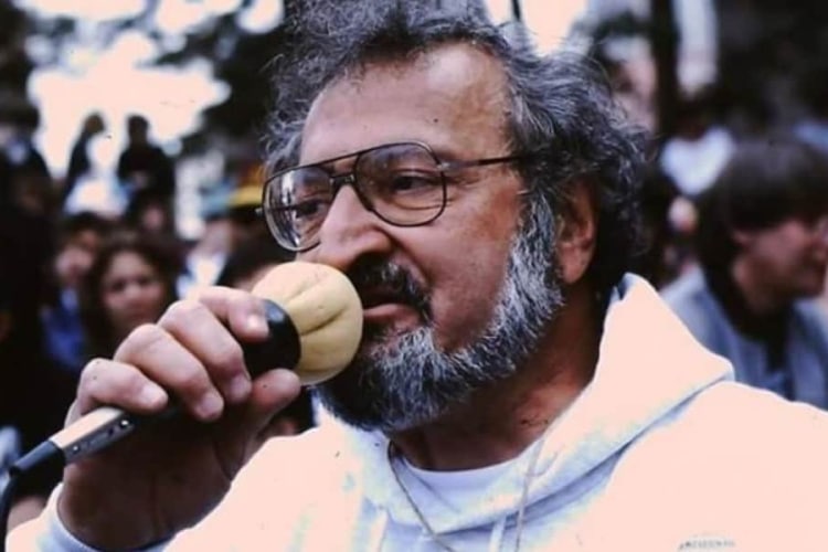 Jack Herer speaking passionately into a microphone at a public event.